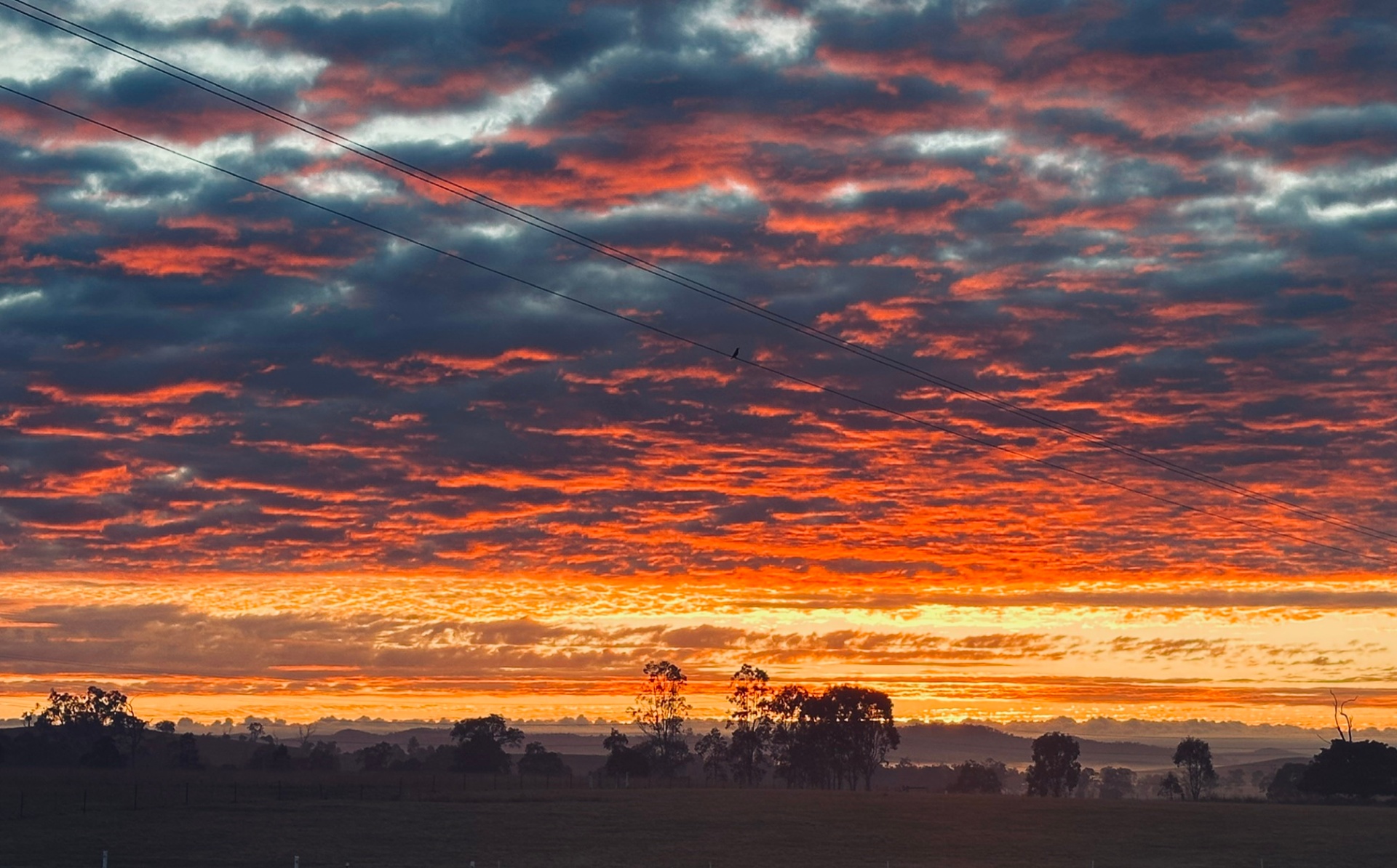 Fiery red and orange sunrise over the hills beyond the sanctuary