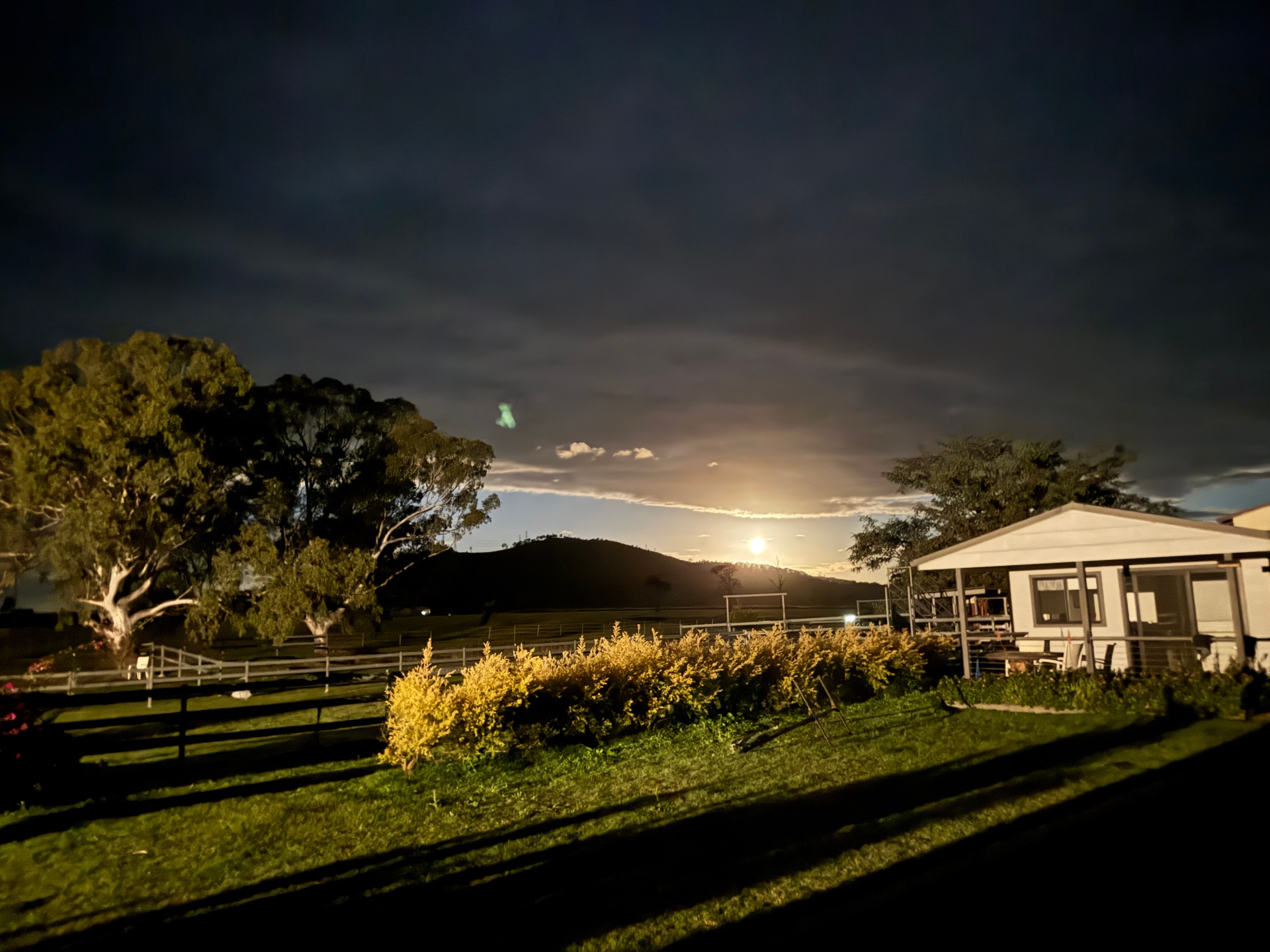 Moon rising over the hills beyond the sanctuary cabin at dusk
