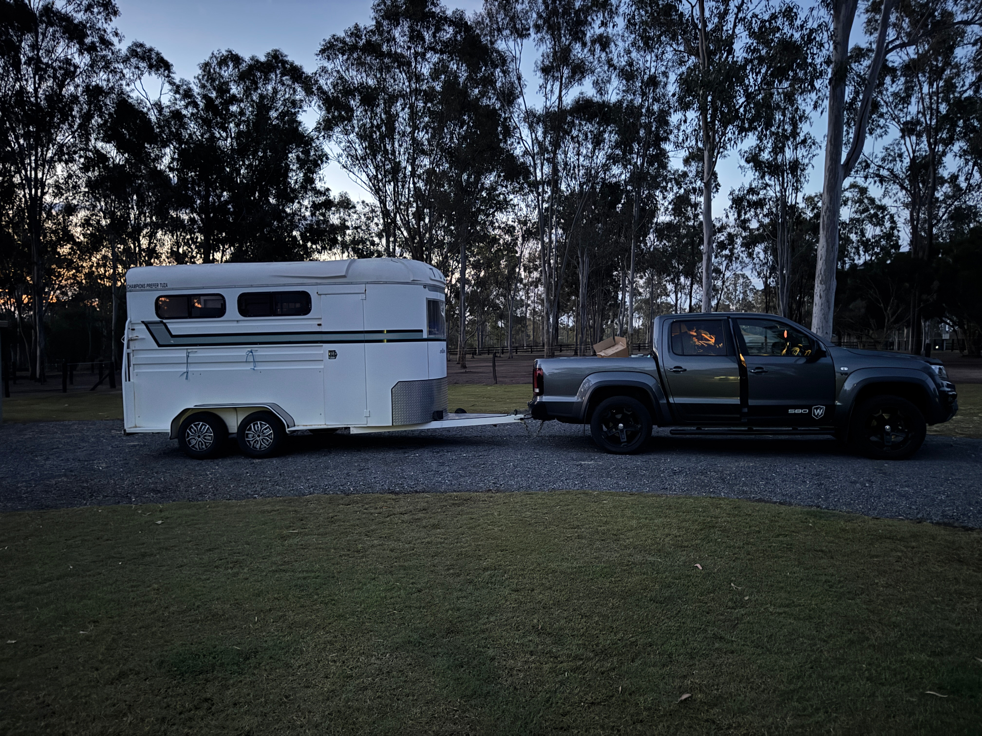 Horse float and ute at the sanctuary at dusk, arriving with a rescue